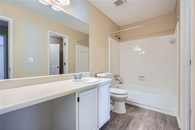 full bath featuring visible vents, toilet, shower / washtub combination, wood finished floors, and vanity