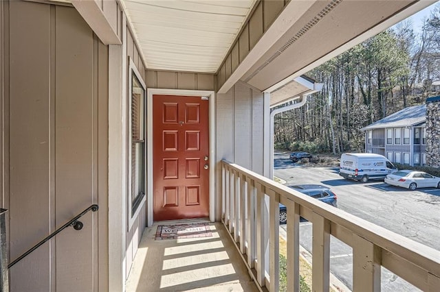 doorway to property with uncovered parking and board and batten siding