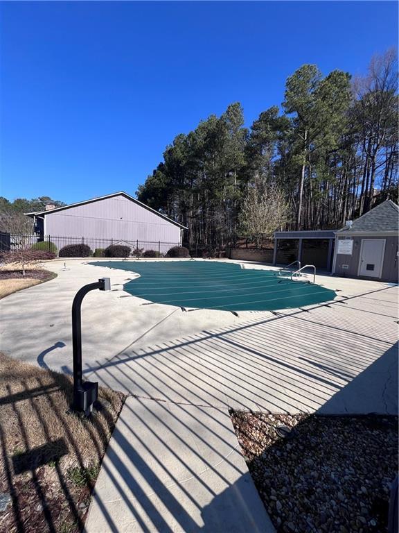 pool featuring a patio and fence