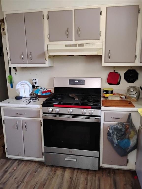 137 Timber Ln, Waycross, GA 31503 - kitchen featuring stainless steel gas range, under cabinet range hood, light countertops, dark wood-style floors, and gray cabinetry