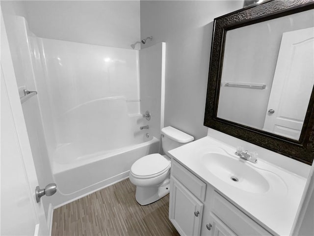 full bathroom featuring wood-type flooring, toilet, bathing tub / shower combination, and vanity