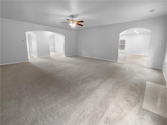 carpeted spare room with ceiling fan