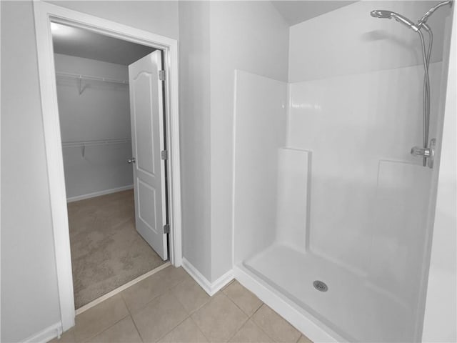 bathroom featuring tile patterned flooring and walk in shower