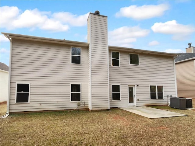 back of house featuring a patio, central AC, and a lawn