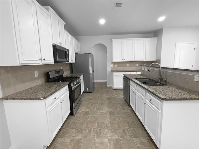 kitchen featuring stainless steel appliances, sink, and white cabinets