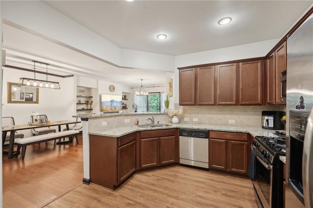 4430 Cedar Bridge Walk, Suwanee, GA 30024 - kitchen with a sink, light wood-type flooring, a peninsula, appliances with stainless steel finishes, and a notable chandelier