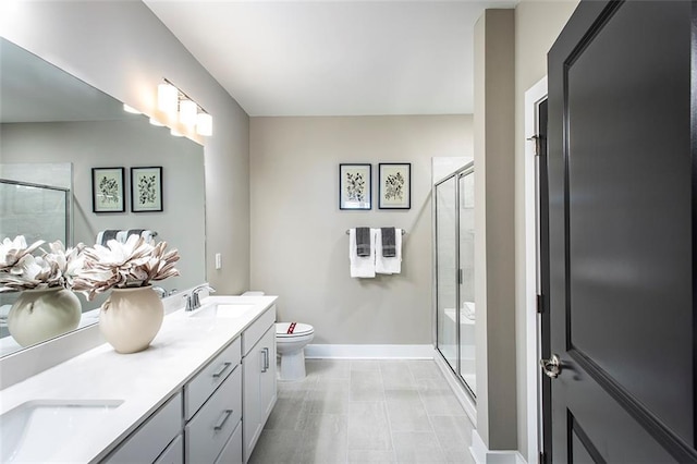 bathroom with vanity, toilet, and an enclosed shower