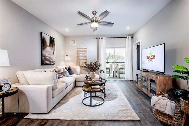 living room featuring wood-type flooring and ceiling fan