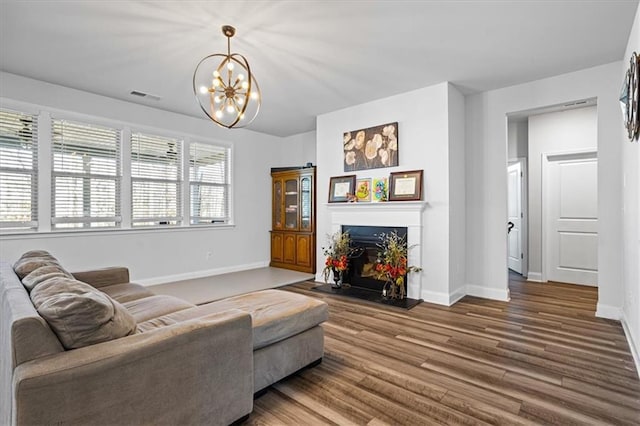 living room featuring wood-type flooring and a notable chandelier