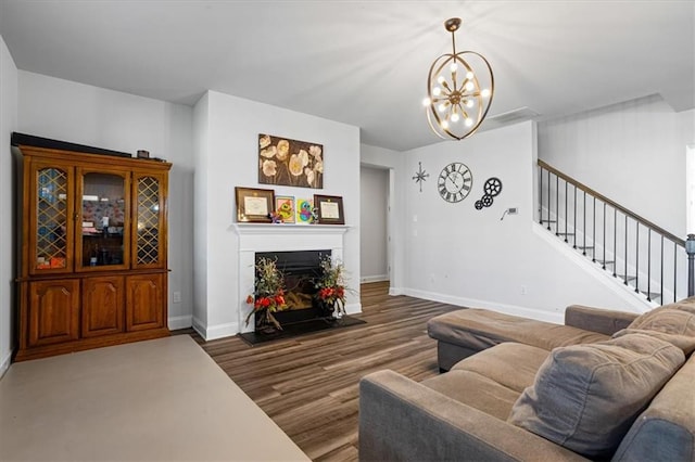 living room featuring dark hardwood / wood-style floors and an inviting chandelier