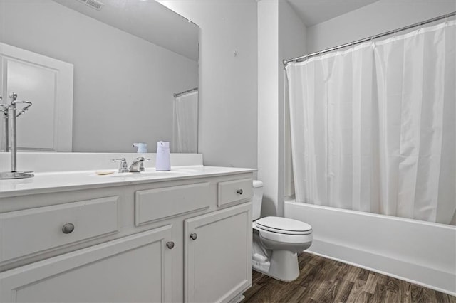 full bathroom featuring vanity, toilet, wood-type flooring, and shower / tub combo