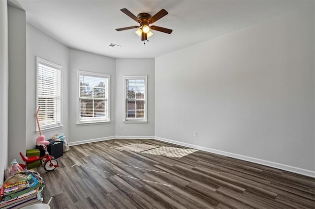 unfurnished room featuring dark hardwood / wood-style floors and ceiling fan