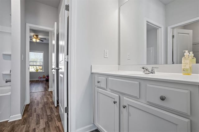 bathroom featuring ceiling fan, hardwood / wood-style floors, and vanity