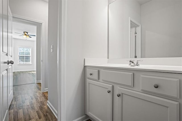 bathroom featuring wood-type flooring, vanity, and ceiling fan