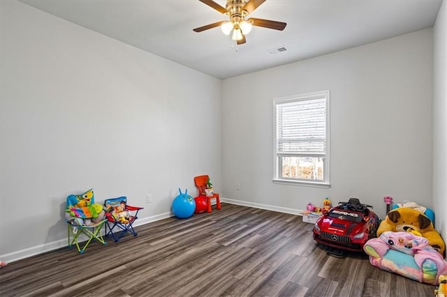 recreation room with dark hardwood / wood-style floors and ceiling fan