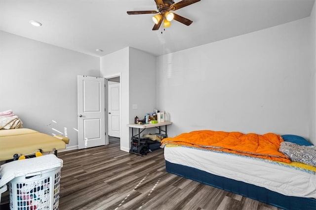 bedroom with ceiling fan and dark hardwood / wood-style floors