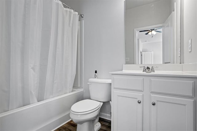 full bathroom featuring vanity, hardwood / wood-style flooring, ceiling fan, toilet, and shower / tub combo