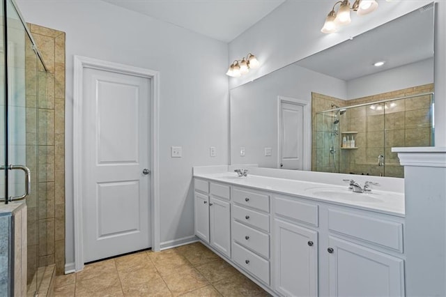 bathroom with tile patterned flooring, vanity, and a shower with shower door