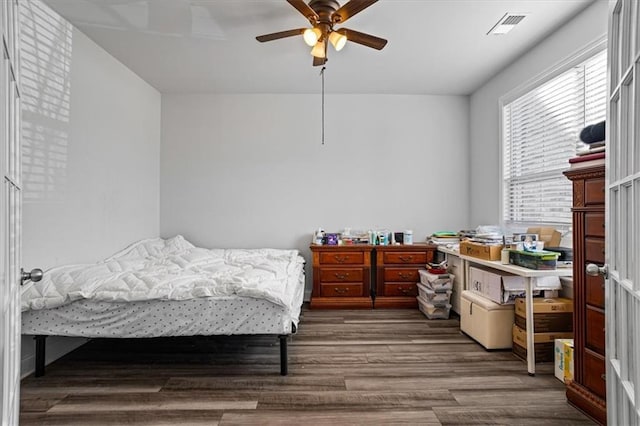 bedroom featuring ceiling fan and dark hardwood / wood-style floors