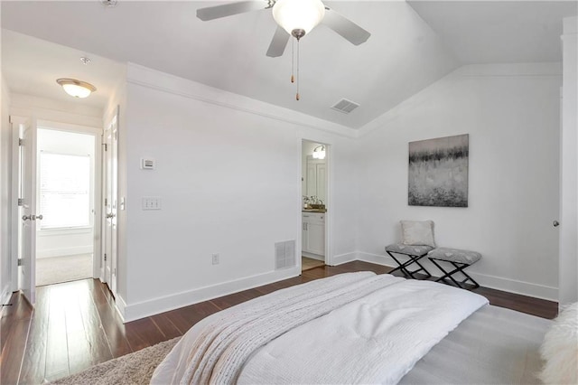 bedroom featuring connected bathroom, dark hardwood / wood-style floors, ceiling fan, and lofted ceiling