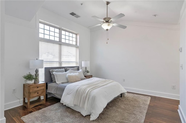 bedroom with vaulted ceiling, ceiling fan, and dark hardwood / wood-style floors