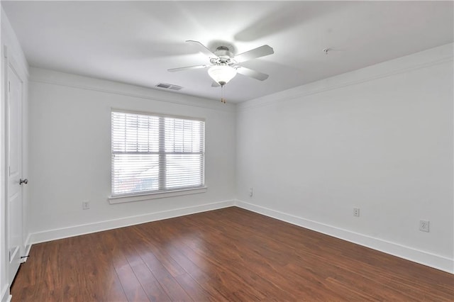 spare room featuring ceiling fan and dark wood-type flooring