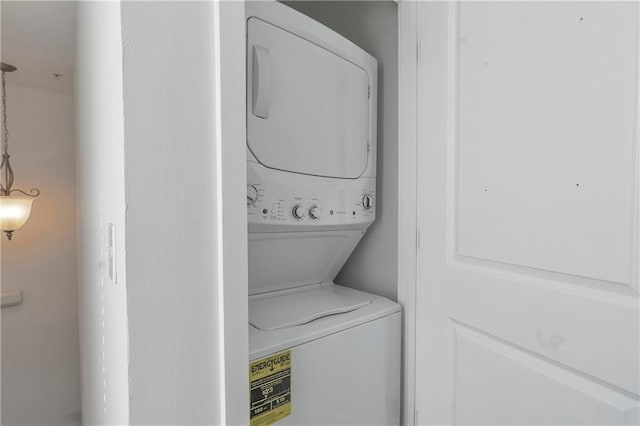 laundry area featuring stacked washing maching and dryer