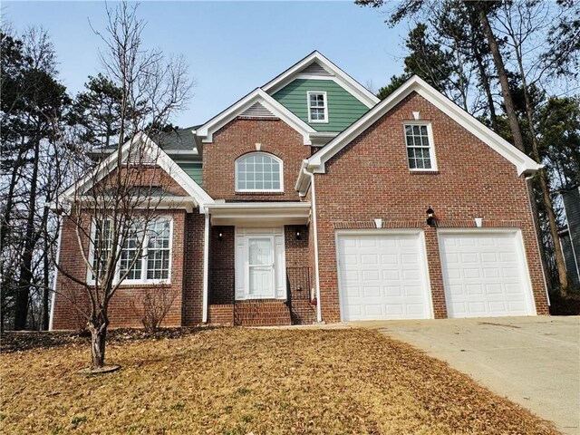 view of front of house with a garage and a front yard