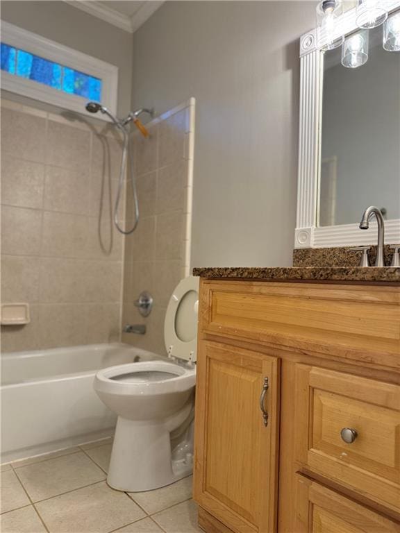 full bathroom featuring tile patterned flooring, toilet, tiled shower / bath, and crown molding