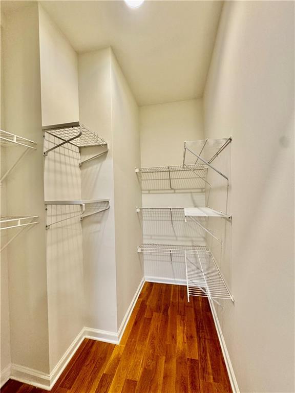 hallway featuring light wood-type flooring and ornamental molding