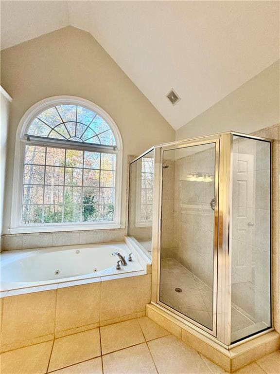 bathroom with tile patterned flooring, separate shower and tub, and lofted ceiling