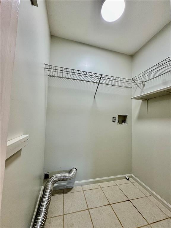 laundry room with tile patterned floors and hookup for a washing machine