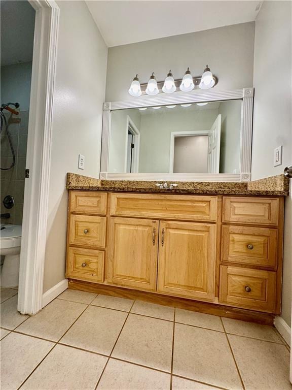 bathroom featuring tile patterned flooring, vanity, and tub / shower combination