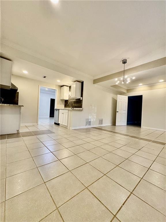 unfurnished living room with a raised ceiling, light tile patterned floors, an inviting chandelier, and ornamental molding