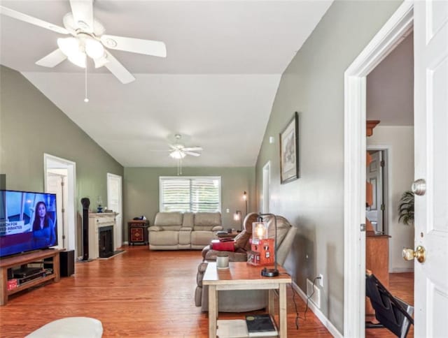 904 Corinth Five Points Rd, Buchanan, GA 30113 - living room featuring a ceiling fan, wood finished floors, lofted ceiling, and a fireplace