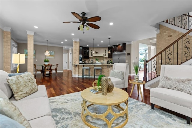 2990 Hearthstone Dr, Cumming, GA 30041 - living room featuring decorative columns, dark wood-style floors, a ceiling fan, crown molding, and recessed lighting