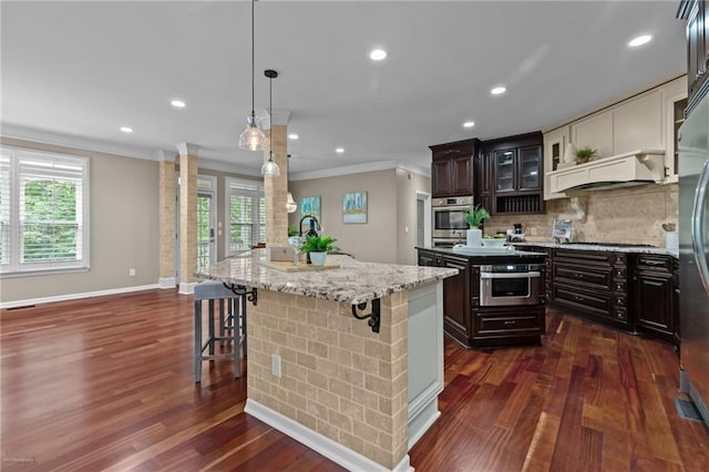 2990 Hearthstone Dr, Cumming, GA 30041 - kitchen with a kitchen island, stainless steel oven, crown molding, dark wood-style floors, and recessed lighting
