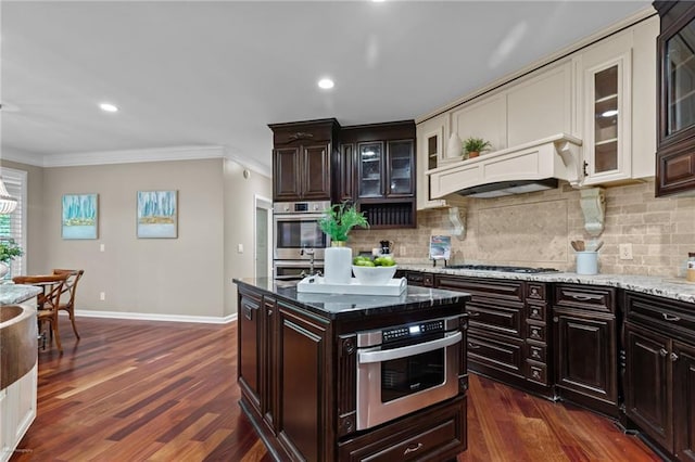 2990 Hearthstone Dr, Cumming, GA 30041 - kitchen featuring crown molding, backsplash, baseboards, dark wood-style floors, and stainless steel appliances