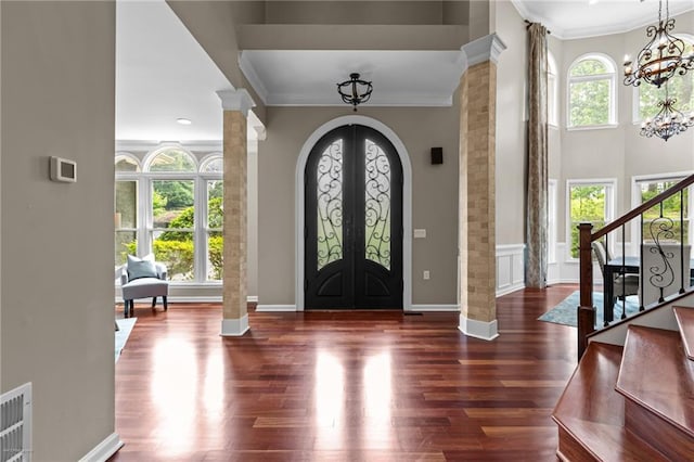 2990 Hearthstone Dr, Cumming, GA 30041 - foyer with a chandelier, crown molding, decorative columns, stairs, and wood finished floors