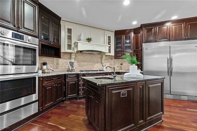 2990 Hearthstone Dr, Cumming, GA 30041 - kitchen featuring stainless steel appliances, a sink, a warming drawer, dark stone countertops, and recessed lighting