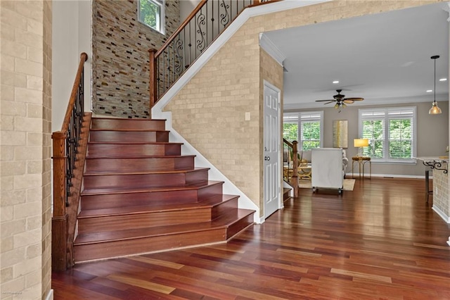 2990 Hearthstone Dr, Cumming, GA 30041 - stairway with wood finished floors, a ceiling fan, baseboards, recessed lighting, and crown molding