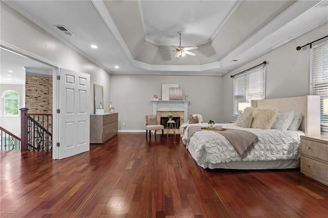 2990 Hearthstone Dr, Cumming, GA 30041 - bedroom featuring ornamental molding, a raised ceiling, dark wood-style floors, a fireplace, and baseboards