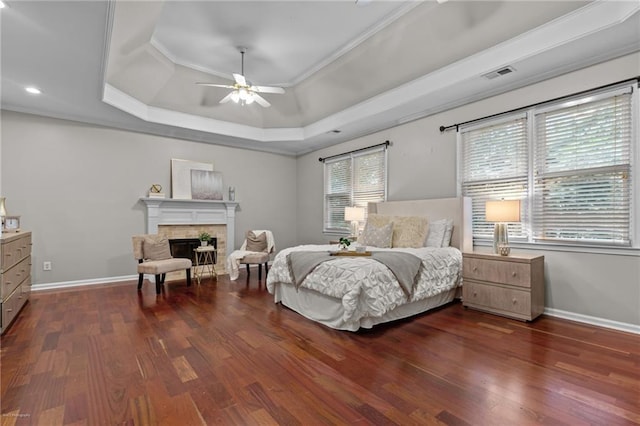 2990 Hearthstone Dr, Cumming, GA 30041 - bedroom with a raised ceiling, ornamental molding, wood finished floors, a fireplace, and baseboards