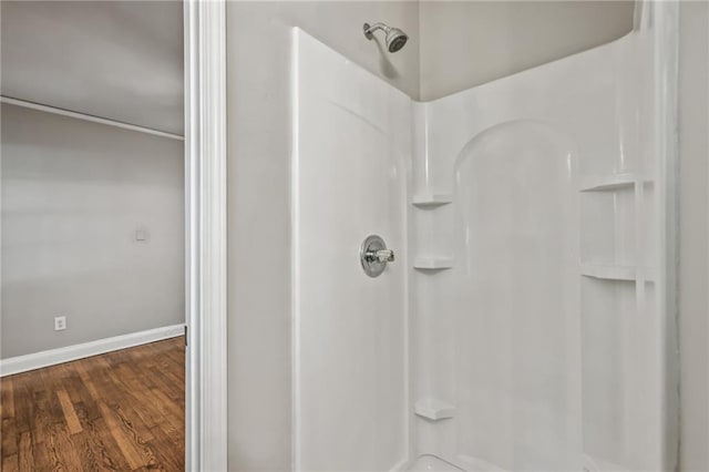 bathroom with a shower and hardwood / wood-style flooring