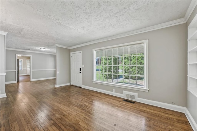 unfurnished room with a textured ceiling, hardwood / wood-style flooring, and ornamental molding