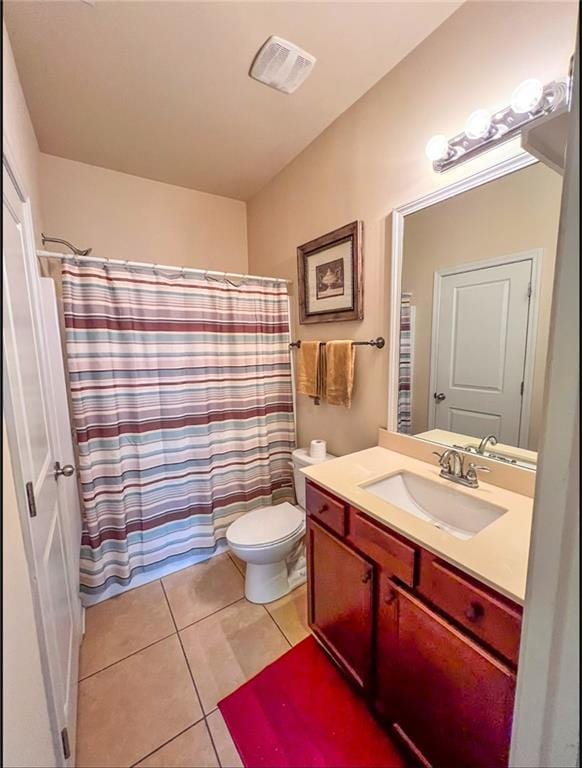 bathroom with a shower with curtain, tile patterned flooring, vanity, and toilet