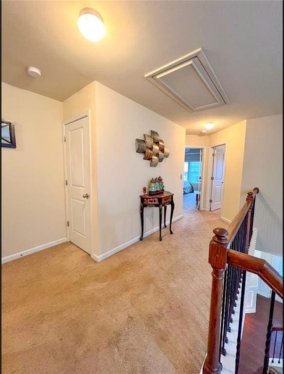 hallway featuring light colored carpet