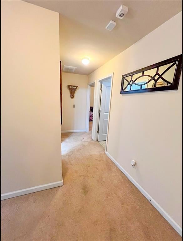 hallway with carpet floors