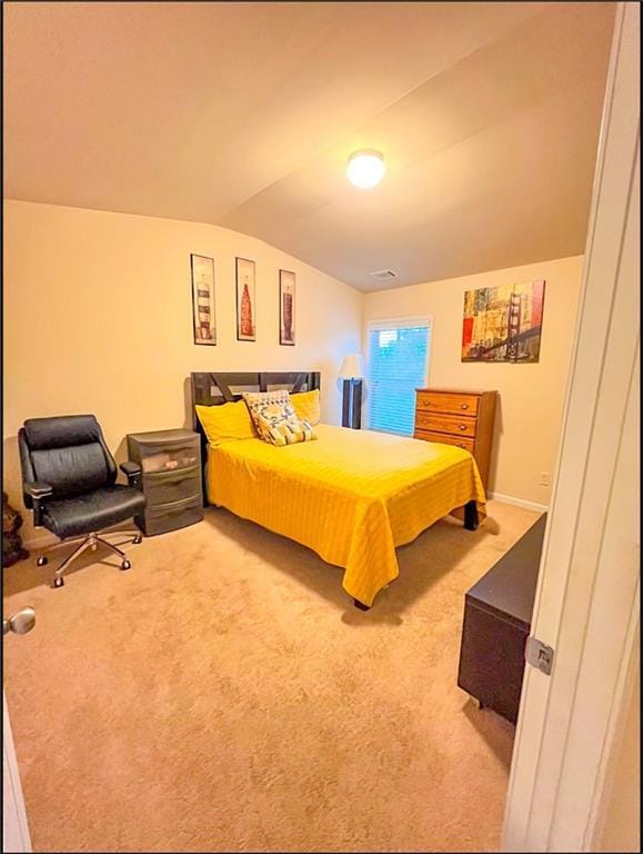 bedroom with carpet flooring and lofted ceiling