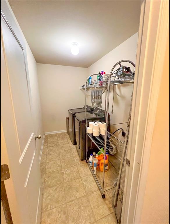 washroom featuring washing machine and clothes dryer